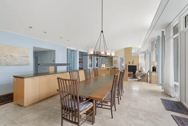a dining room with furniture a chandelier and window
