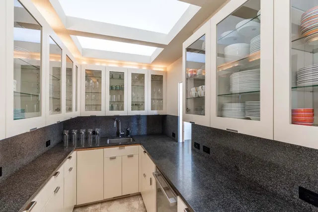 a kitchen with stainless steel appliances granite countertop a sink a stove and a refrigerator