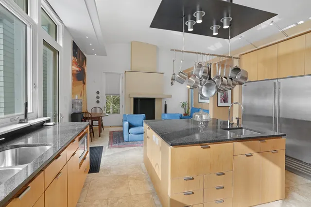 a kitchen with stainless steel appliances granite countertop a sink a stove and a refrigerator