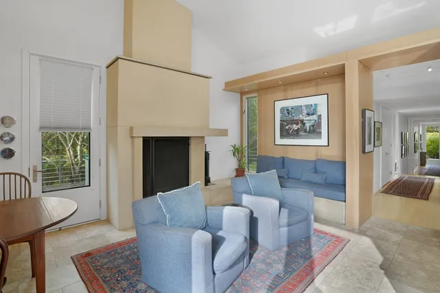 a patio with a table and chairs and a barbeque