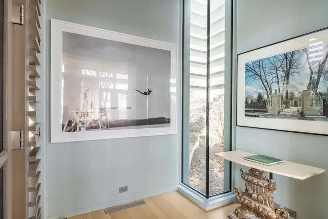 a bedroom with a bed and a large window
