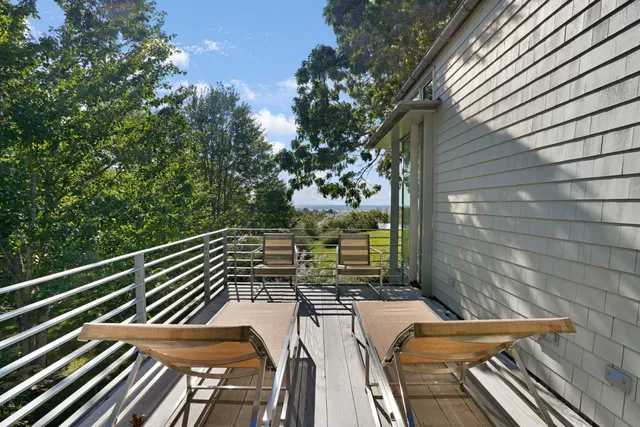 a bathroom with a granite countertop sink a toilet a mirror and shower