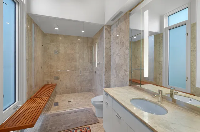 a bedroom with a bed and a flat tv screen on a dresser