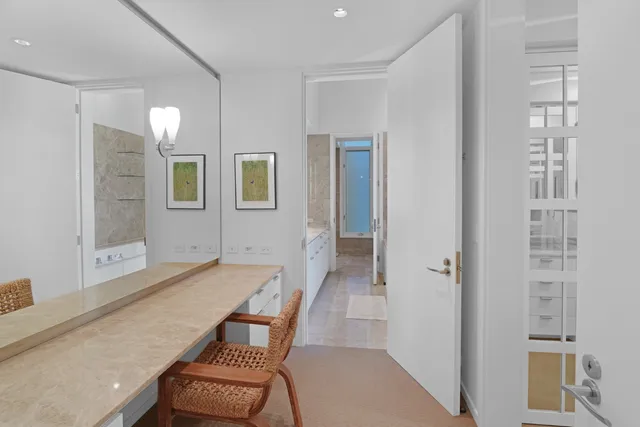 a bedroom with a bed and a flat tv screen on the dresser