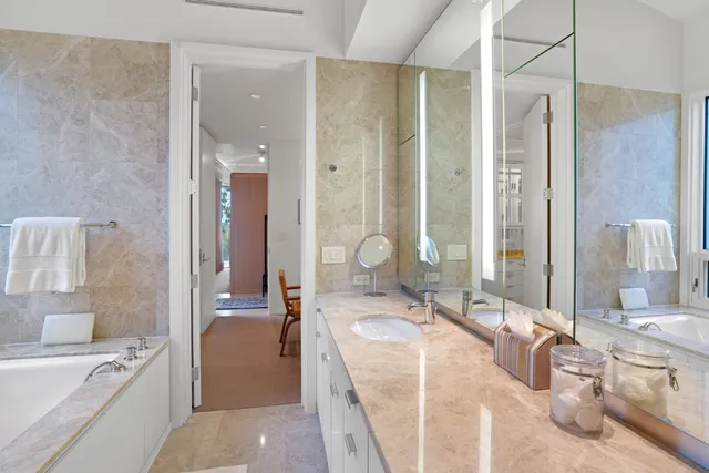 a bedroom with a bed and a flat tv screen on the dresser