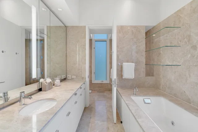 a bathroom with a sink a mirror and a vanity