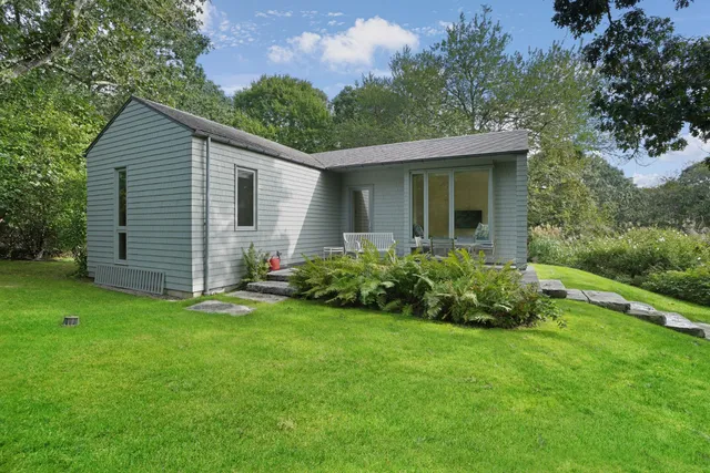 a view of a patio with table and chairs with wooden floor and fence