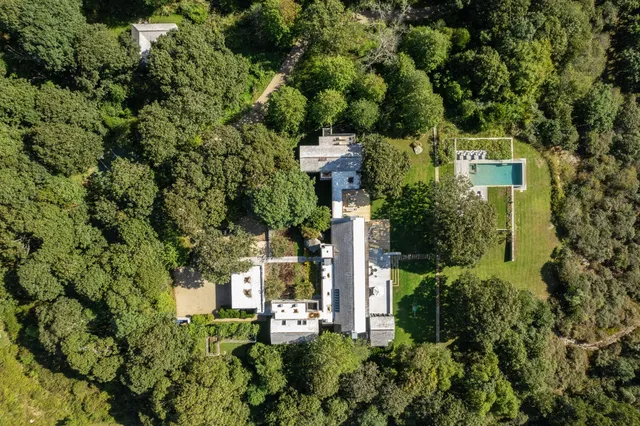 an aerial view of a house with a yard