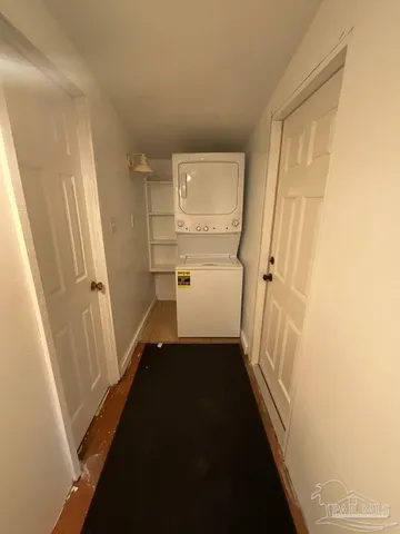 a view of a hallway with white walls and stairs