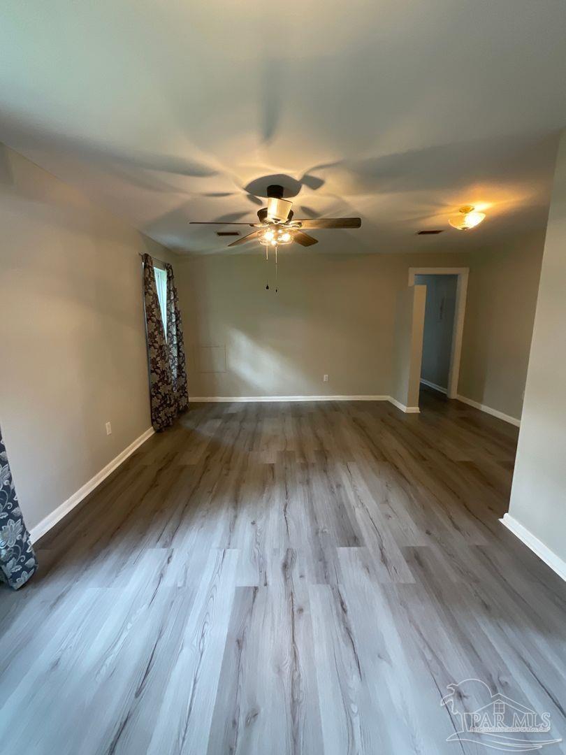 809 West Government Street Pensacola, FL 32502 - Photo 7 of 15 wooden floor in an empty room with a window
