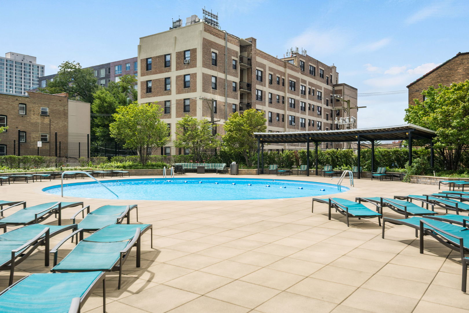 3930 North Pine Grove Avenue, Unit 1606 Chicago, IL 60613 - Photo 15 of 17 a view of a swimming pool with chairs and tables