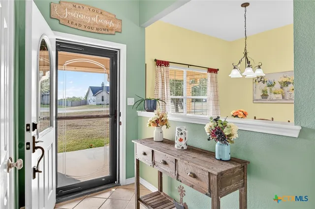 a living room with furniture a flat screen tv and a window