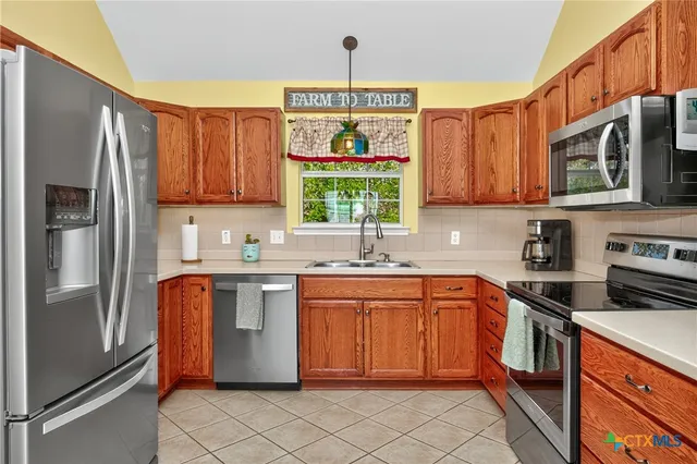 a kitchen with a sink stove and microwave
