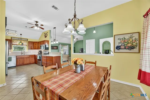 a view of a hallway with livingroom and dining area
