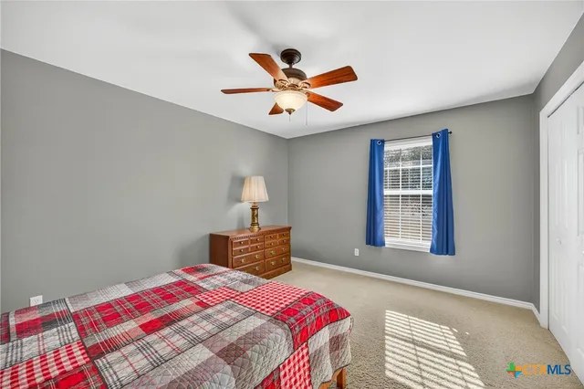 a bedroom with a bed and a dresser