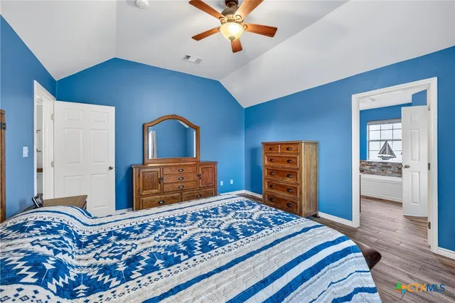 a living room with furniture wooden floor and a large window