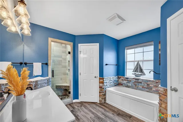 a bathroom with a sink a shower and a mirror