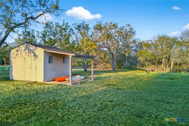 a view of green field with trees