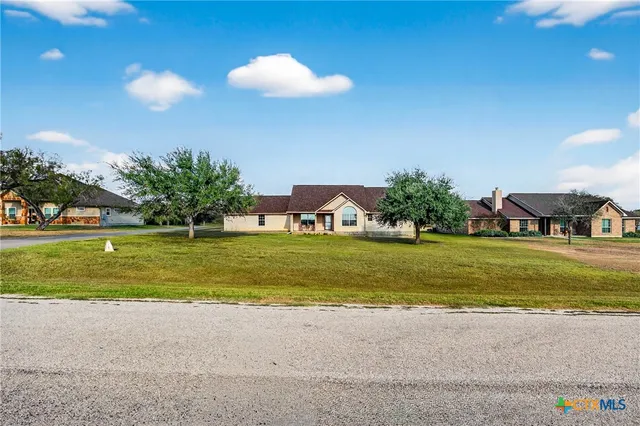 a view of a house with a swimming pool and a yard