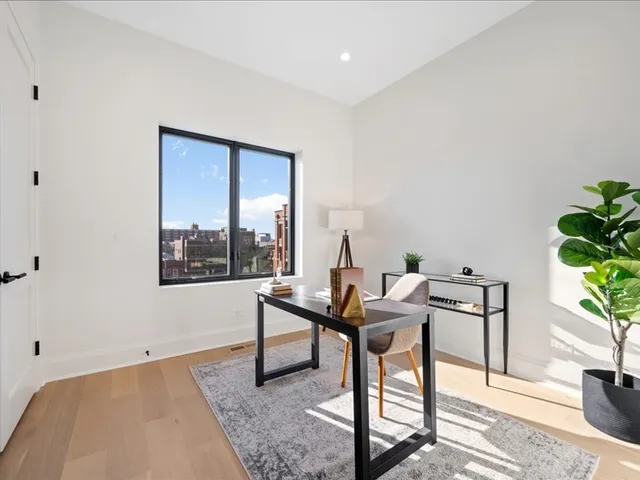 a work room with furniture and a potted plant