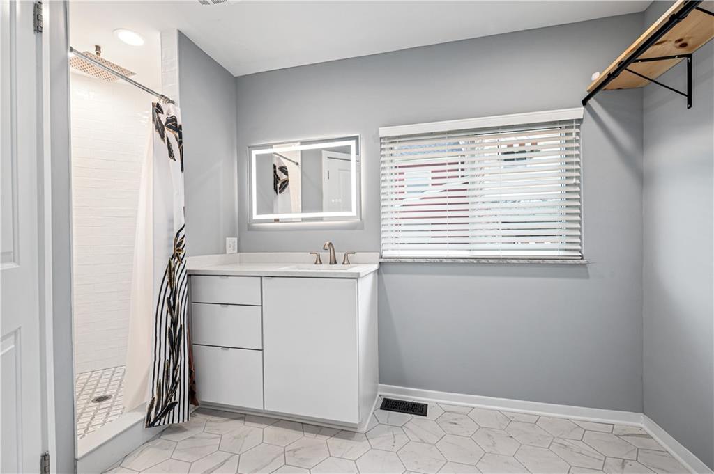 4808 Lima Way Pittsburgh, PA 15224 - Photo 16 of 26 a bathroom with a sink and a mirror