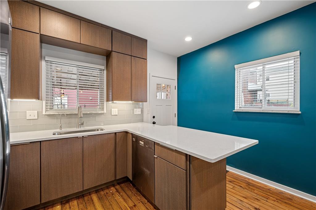 4808 Lima Way Pittsburgh, PA 15224 - Photo 4 of 26 a kitchen with a sink and wooden cabinets