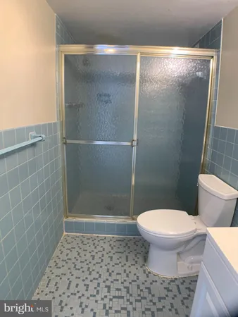 a bathroom with a toilet and a shower