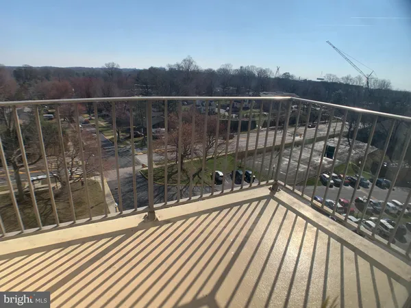 a view of a balcony with a yard