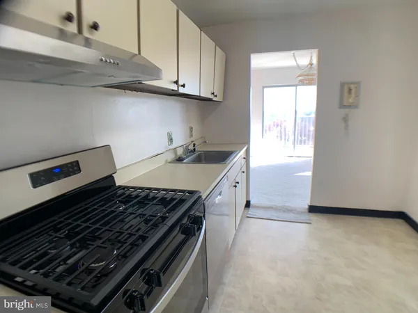 a stove top oven sitting inside of a kitchen