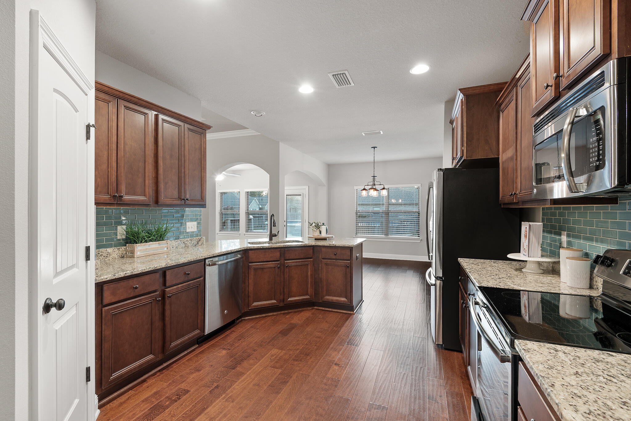 399 Old Ferry Road Santa Rosa Beach, FL 32459 - Photo 12 of 51 a kitchen with stainless steel appliances granite countertop wooden cabinets a stove top oven a sink and dishwasher