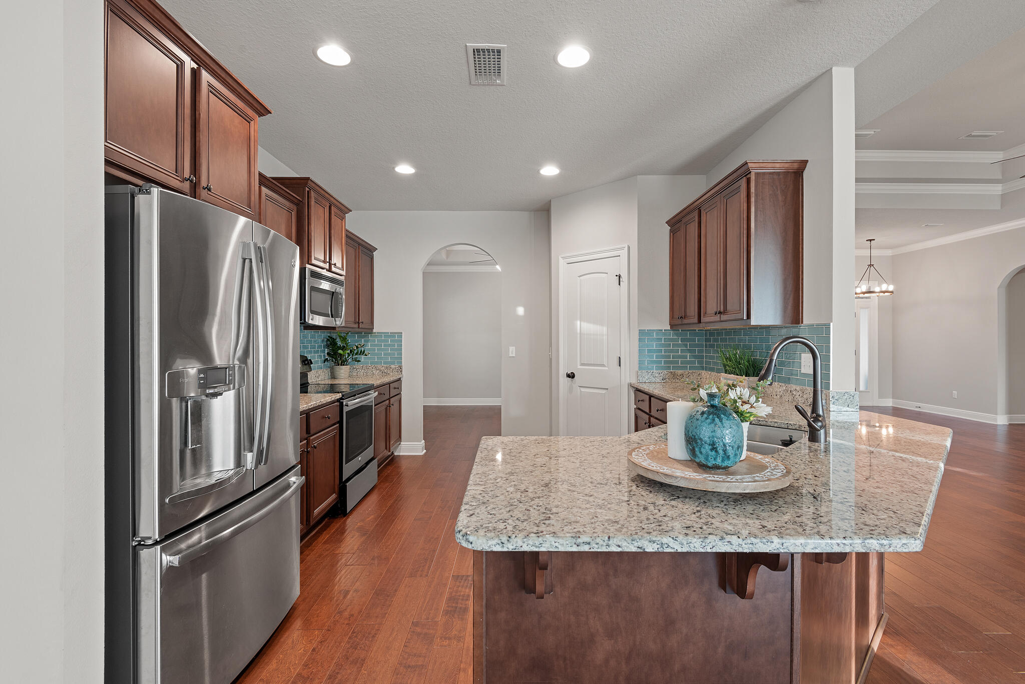 399 Old Ferry Road Santa Rosa Beach, FL 32459 - Photo 14 of 51 a kitchen with granite countertop kitchen island stainless steel appliances a refrigerator a sink and a center island