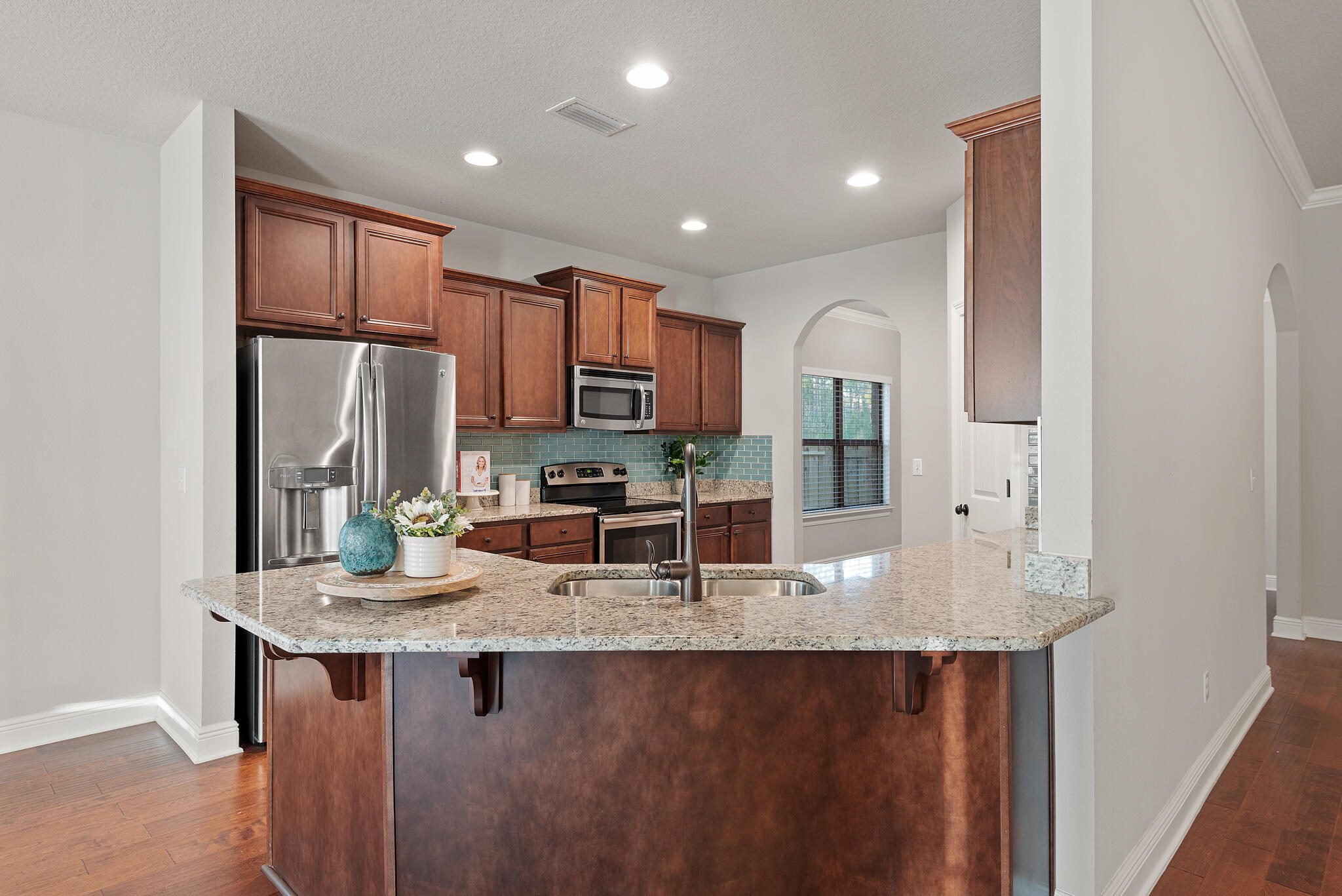 399 Old Ferry Road Santa Rosa Beach, FL 32459 - Photo 15 of 51 a kitchen with granite countertop kitchen island stainless steel appliances a refrigerator sink stove microwave and cabinets