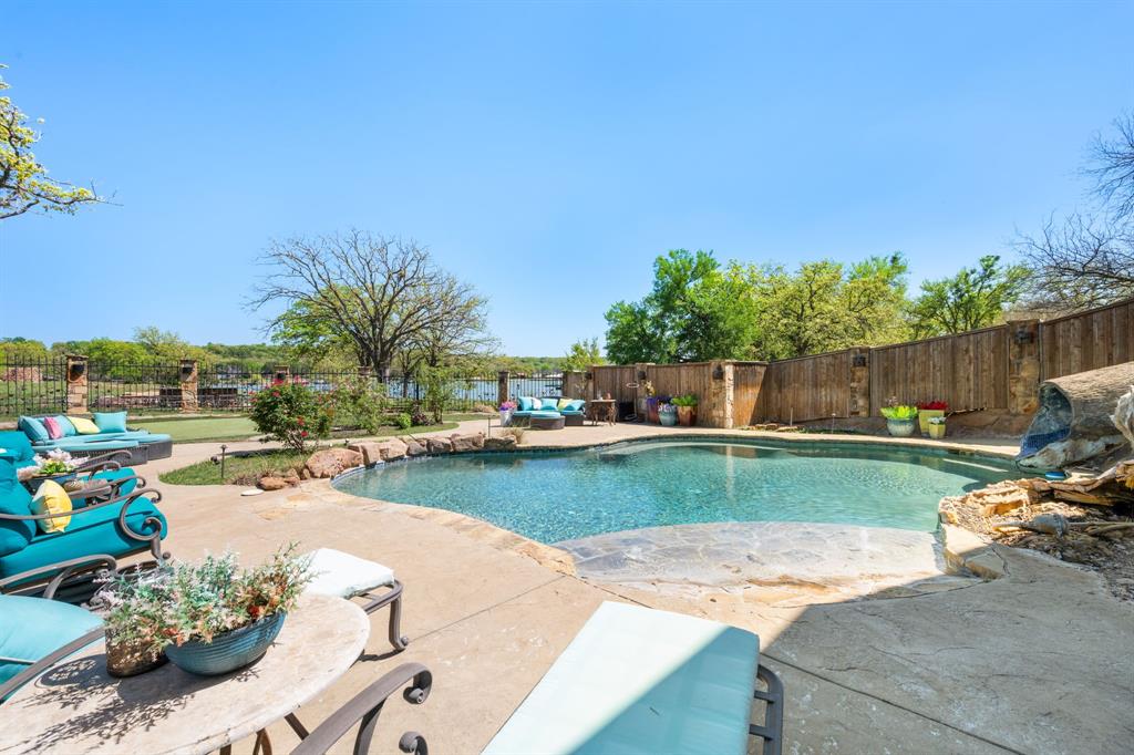 660 Deer Trail Gordon, TX 76453 - Photo 17 of 40 a view of a backyard with couches plants and swimming pool