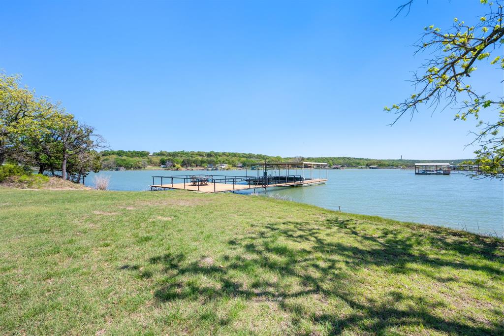 660 Deer Trail Gordon, TX 76453 - Photo 18 of 40 a view of a lake with houses in the back