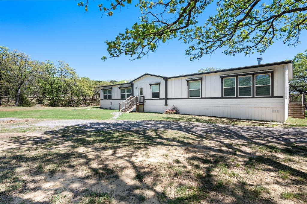 660 Deer Trail Gordon, TX 76453 - Photo 21 of 40 a front view of a house with garden