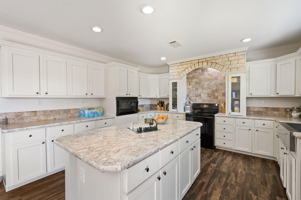 660 Deer Trail Gordon, TX 76453 - Photo 22 of 40 a kitchen with a sink stove and cabinets