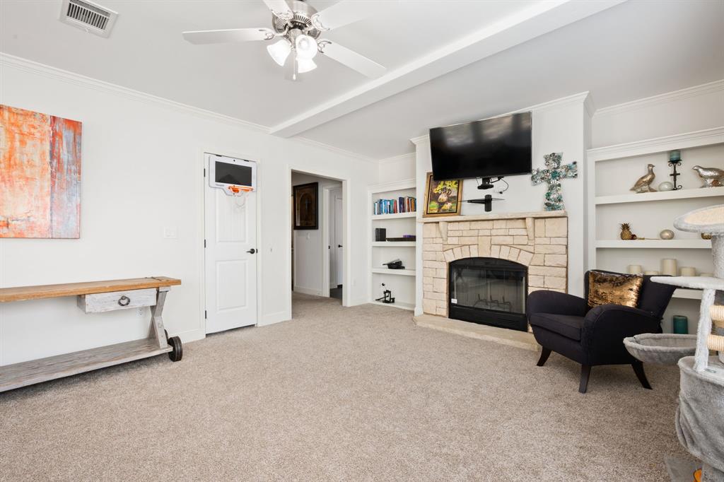 660 Deer Trail Gordon, TX 76453 - Photo 24 of 40 a living room with furniture a flat screen tv and a fireplace