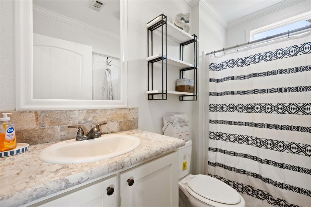 660 Deer Trail Gordon, TX 76453 - Photo 29 of 40 a bathroom with a granite countertop sink toilet and shower