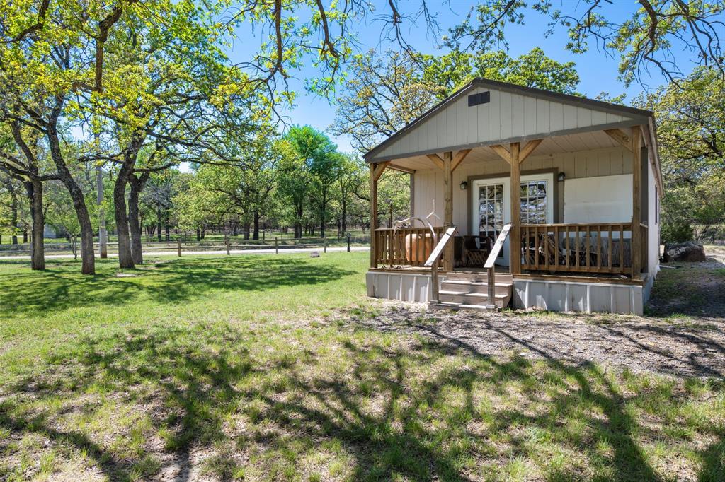 660 Deer Trail Gordon, TX 76453 - Photo 34 of 40 a view of a house with a yard patio and fire pit