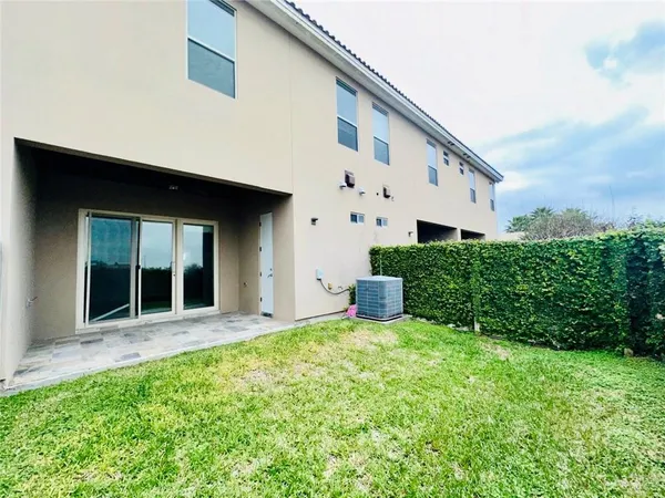 a view of a house with backyard and sitting area