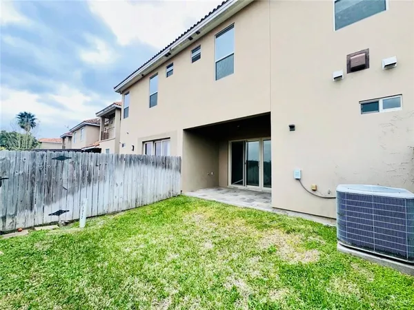 a view of a house with a backyard