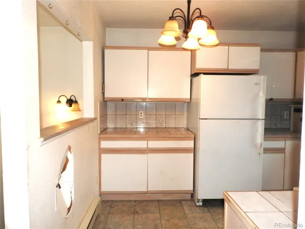 a kitchen with a refrigerator a stove and a window