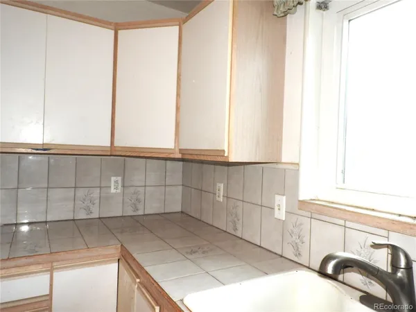a bathroom with a sink and a window