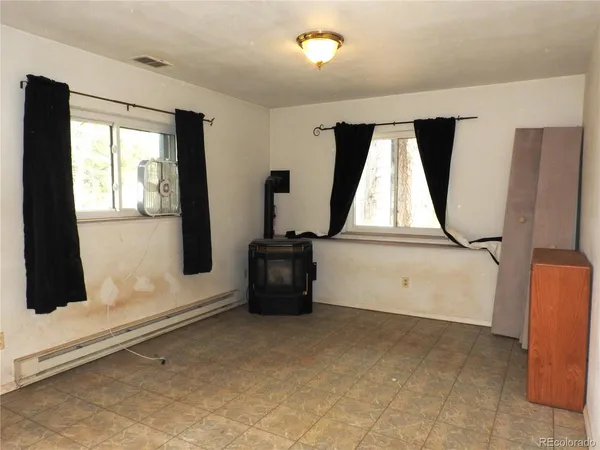 a room with window mirror and windows