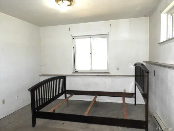 a view of a room with a window and wooden floor