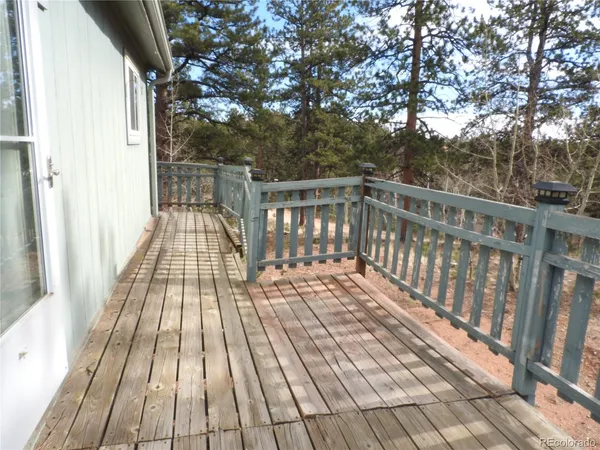 a view of a balcony with two trees