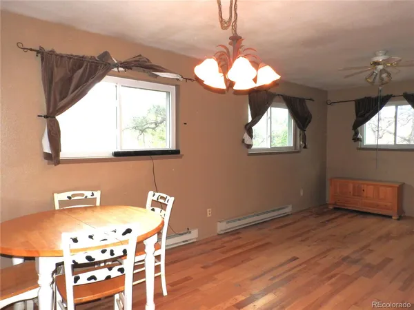 a view of a dining room with furniture and chandelier