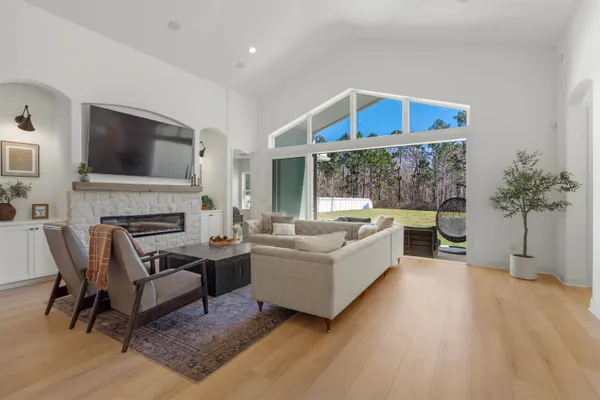 a kitchen with stainless steel appliances granite countertop a sink a stove and a wooden floors