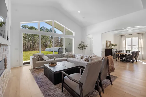 a kitchen with stainless steel appliances granite countertop a sink a stove a dining table and chairs