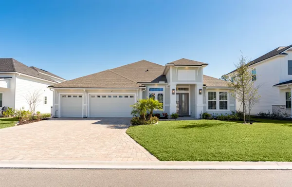 a front view of house with yard and green space